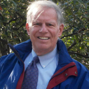 CO4UHC Board member Michael Neil smiles outside.